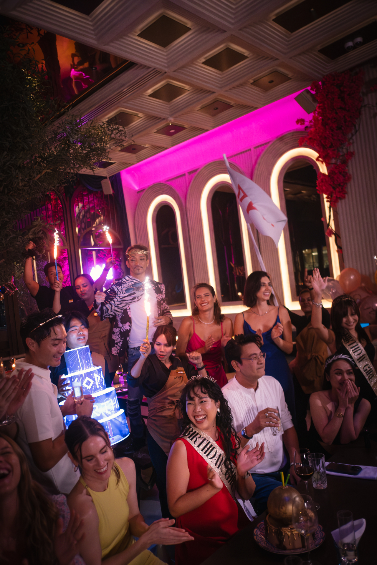 Crowd celebrating a birthday at Aesops
