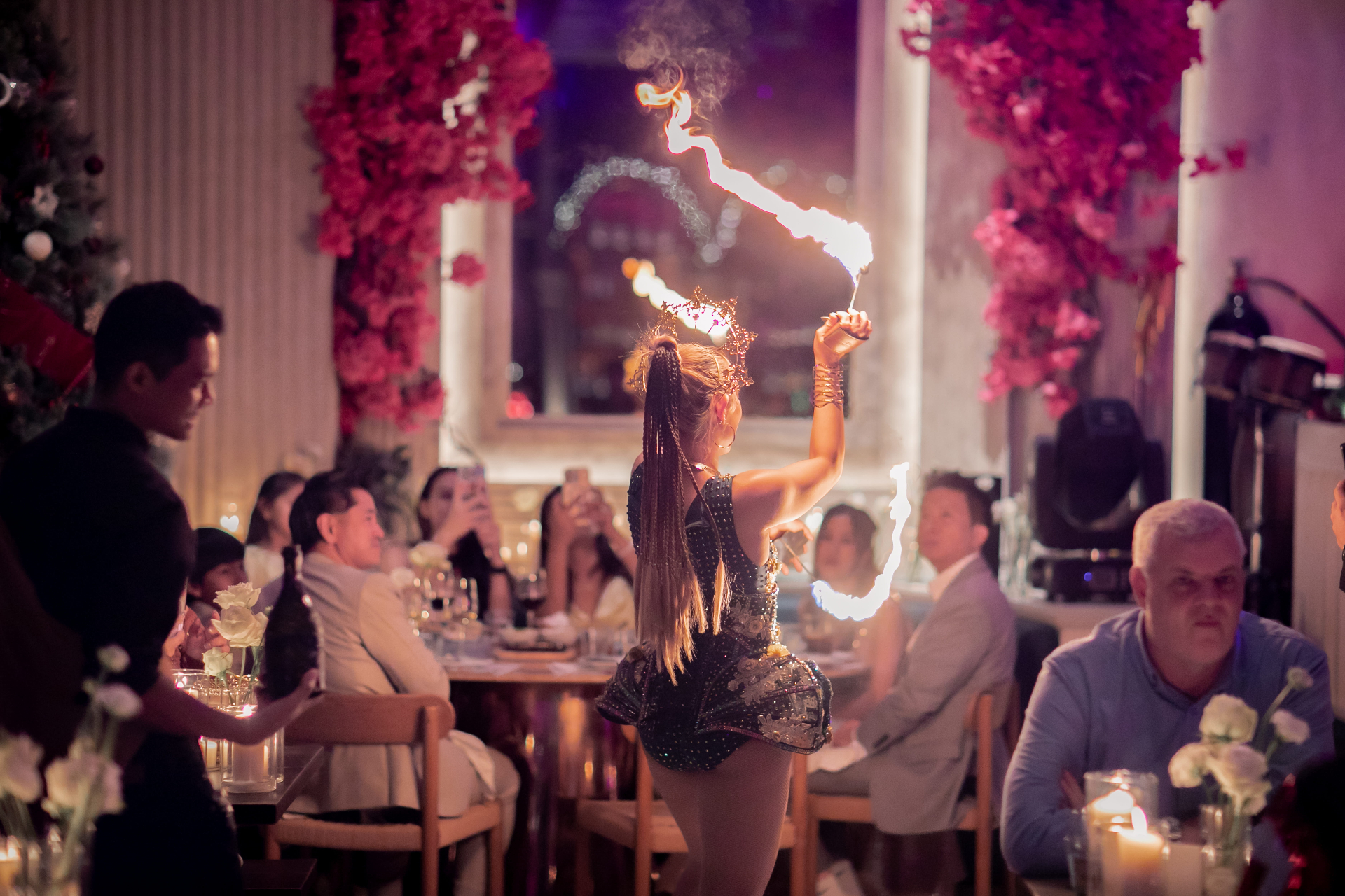 Fire dancer performing between tables at Aesops