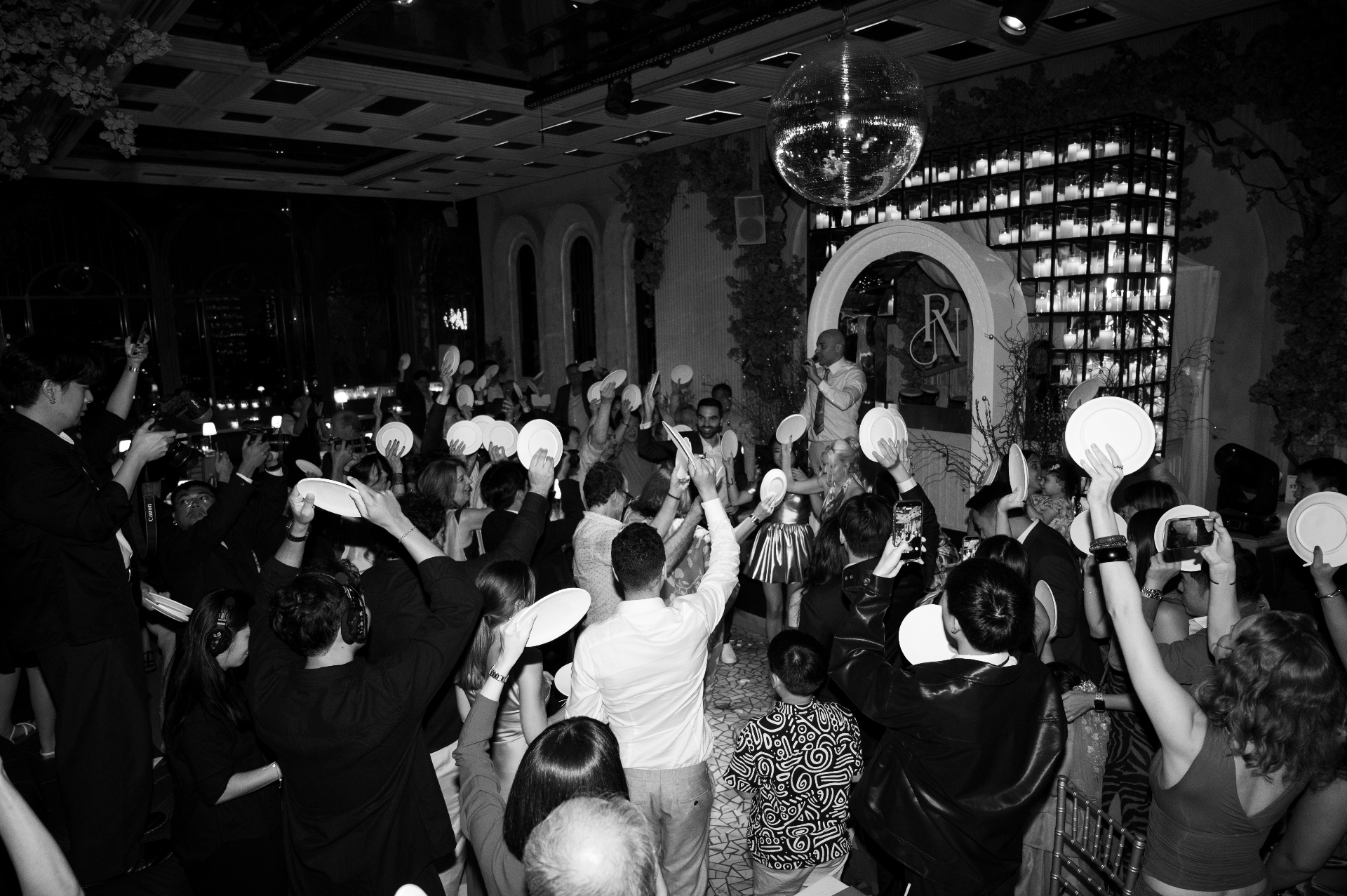 Guests raising plates during the plate smashing ritual at Aesops